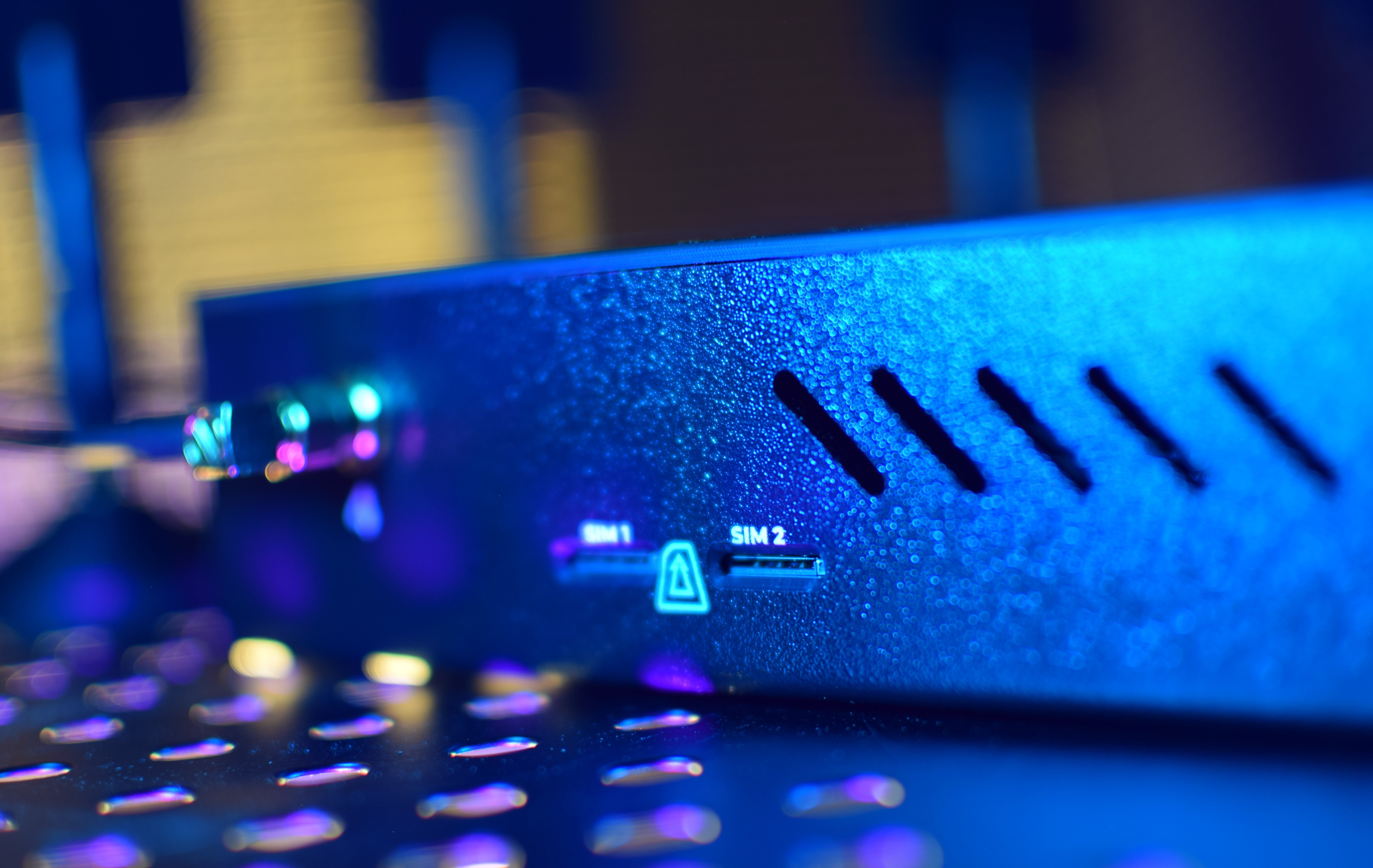 Close-up of a electronic device with SIM card slots on a blurred background