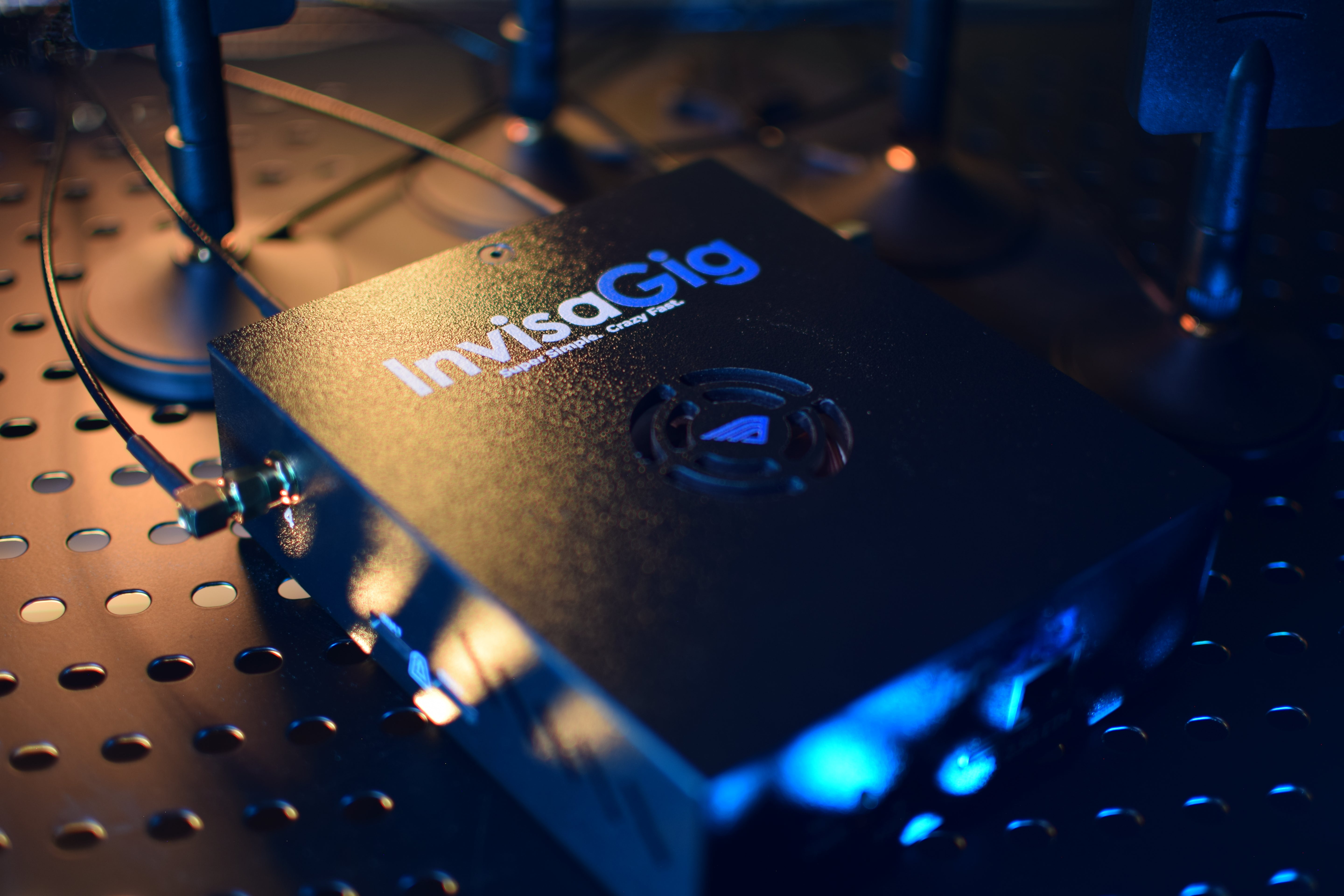 InviscoGig device on a metallic surface with blue lighting